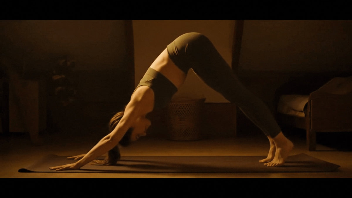 Woman practicing yoga in a downward dog asana